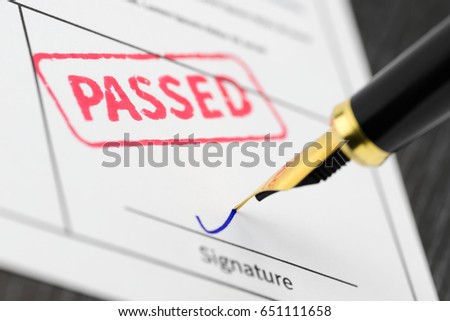 Form close up, fountain pen and passed stamped on a document. Soft focus. Royalty-Free Stock Photo #651111658