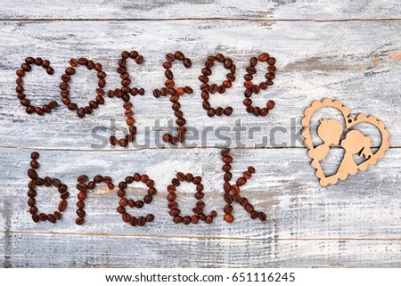 Coffee beans and cartoon heart. Coffee grain and cardboard. Break for kisses.