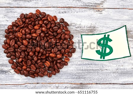 Heap of coffee grain. Currency painted on paper.