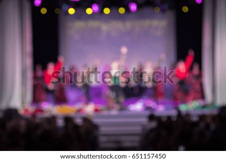 texture blur scene multicolored lights and smoke in concert with silhouettes of people
Background for design, actors on stage