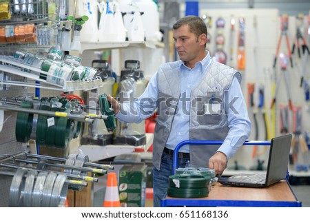 worker stocking shelves in hardware store