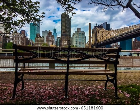 Bench at Roosevelt island, Queensboro bridge and Manhattan in colorful vintage