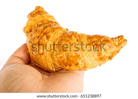Hand showing croissant isolated on white background