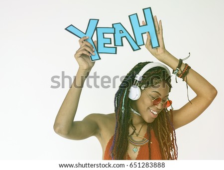 African woman smiling and holding papercraft with the word yeah