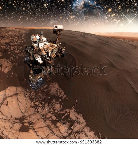 Curiosity rover exploring the surface of Mars. Retouched image. Elements of this image furnished by NASA.