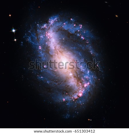 NGC 6217 is a barred spiral galaxy located some 67 million light years away, in the constellation Ursa Minor. Retouched image. Elements of this image furnished by NASA. Royalty-Free Stock Photo #651303412