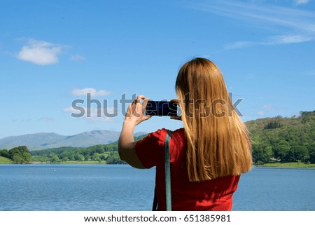 Woman taking a picture with a smart phone