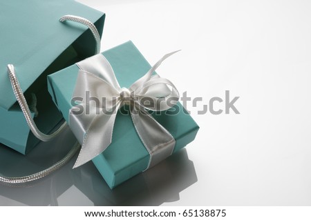 small turquoise box tied with a white ribbon and bag Royalty-Free Stock Photo #65138875