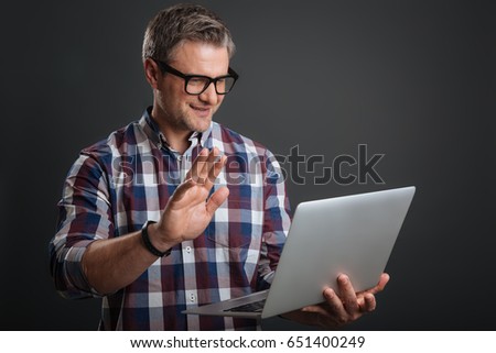 Positive savvy man having a conversation online