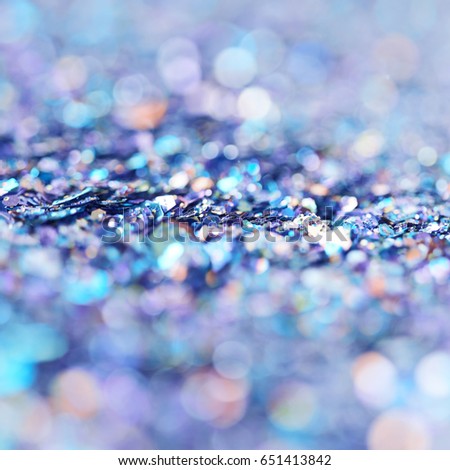 Abstract blue colored background composition made of pile of tinsel shot in bokeh as a backdrop