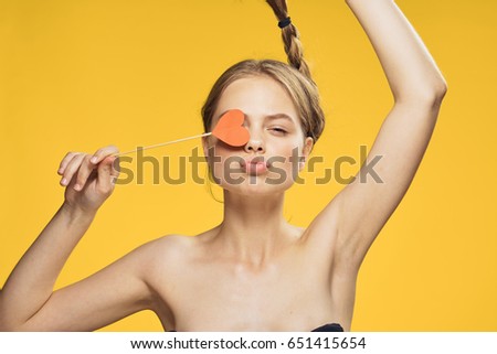 Woman with an accessory on a yellow background                               