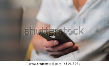 Phone in the hands of a businessman. A European man communicates on business topics by phone. Gadgets and the Internet. Shallow focus