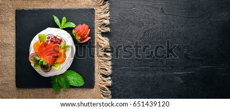Desart with fresh strawberries and mint. Italian cuisine. Top view. On Wooden background.