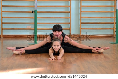 Mother and little girl rhythmic gymnastic portrait.