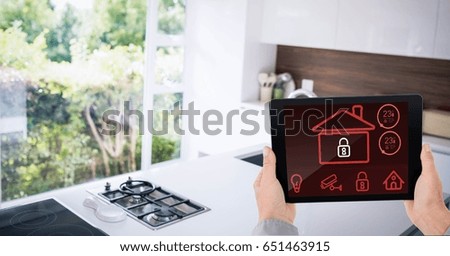 Digital composite of Businessman's hands holding digital tablet with house shape on screen
