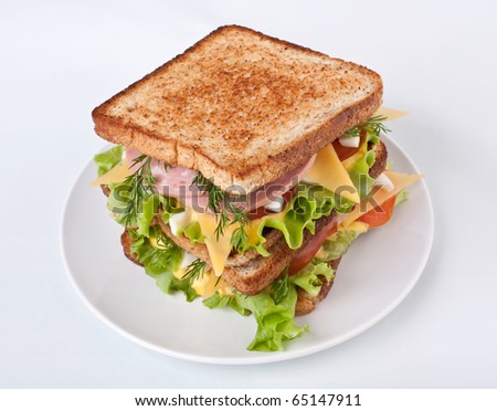 meat, lettuce , cheese and egg salad big sandwich on toasted bread