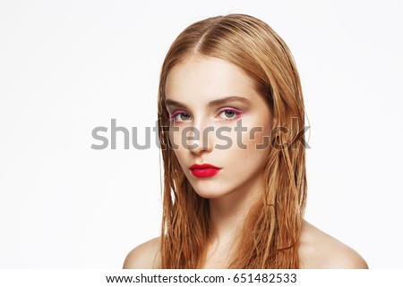 Close-up portrait of young beautiful confident thoughtful girl with bright make up. White background. Isolated.