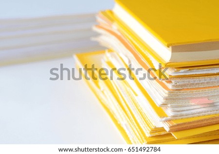 Stack of financial documents on white table with copy space for text,high key tone.