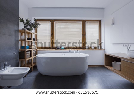 Spacious and comfortable bathroom with freestanding bathtub Royalty-Free Stock Photo #651518575