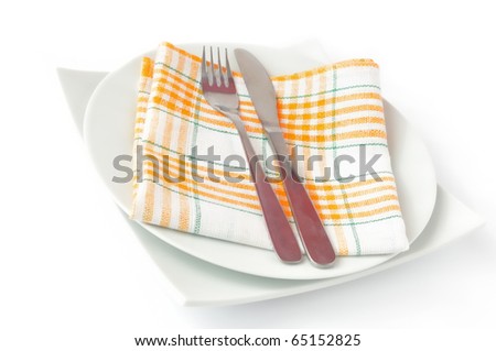 Napkin, folded on a plate with knife and fork c isolated