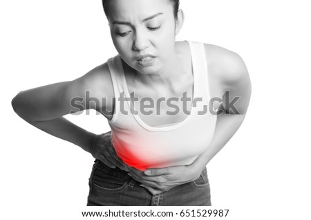 young women holding her belly in pain. isolated on white background. monochrome photo with red as a symbol for the hardening.