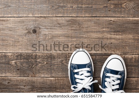 Blue sneakers on wooden background