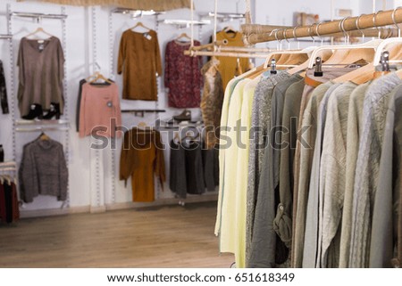 Assortment of warm clothing in modern garment store interior
