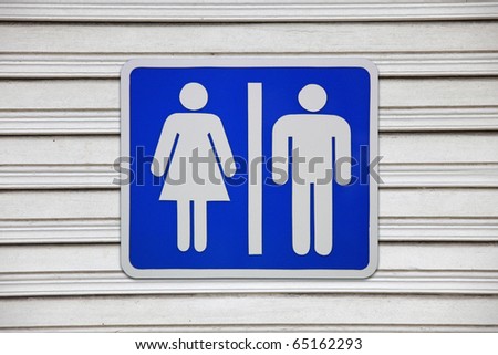 Toilet Sign on wooden door background.