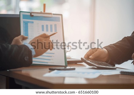 A business team analyzing investment charts at his workplace