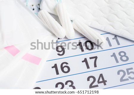 Menstrual calendar with tampons and pads. Menstruation cycle. Hygiene and protection.