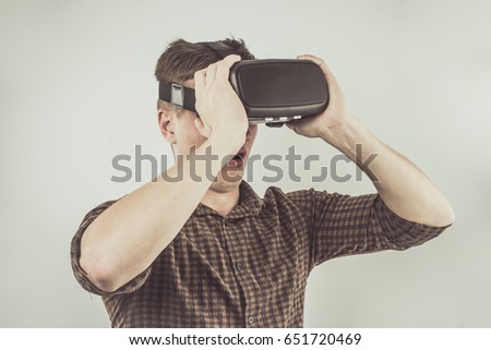 Handsome Young Man Using Virtual Reality Headset. Using Smartphone With VR Glasses. The Immersion in the Virtual World!