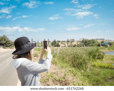 Tourist are taking a picture with a smartphone on a good day. (vintage tone)
