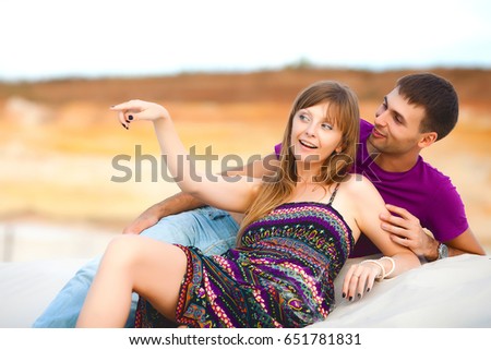 Lovers lying on sand