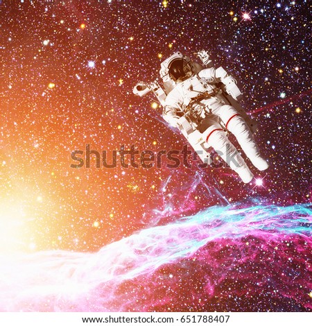 Astronaut in outer space. Nebula on the background. Elements of this image furnished by NASA. 