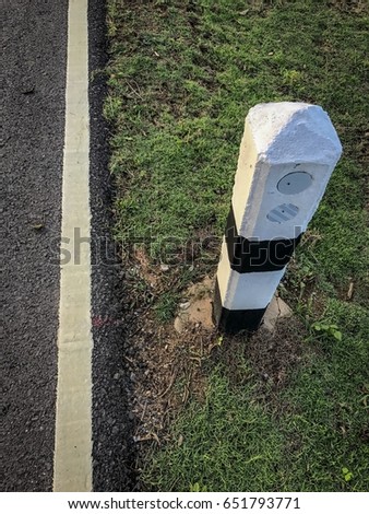 The mile pillars are located beside the road running on the ground.