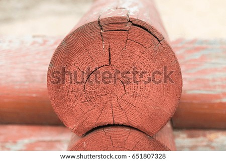 corner red round logs in the sand