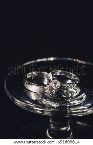 Wedding ring on wine glass for bride and groom on wedding day.
