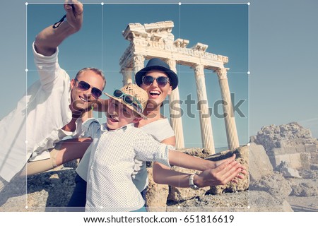 Positive young family take a summer vacation selfie photo on antique sights view