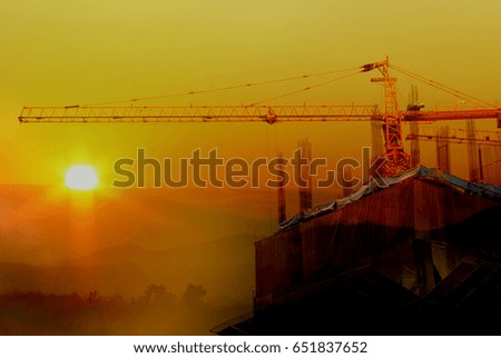 Double exposure building Construction with Crane, sunset blur