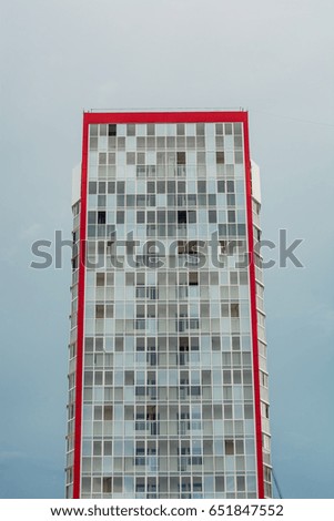 A high-rise multi-storey building with only a cloudy evening sky. 