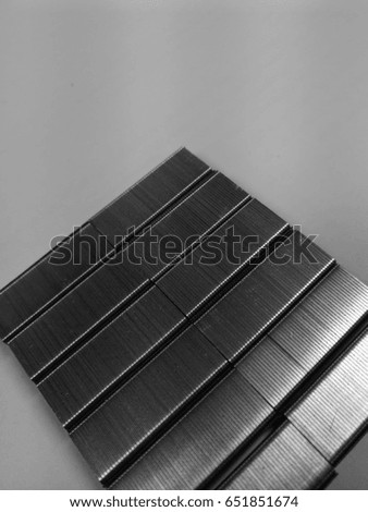 Picture in black and white tone.Close-up staples on white background ,Stack of metal staples ,stack of metal staples for stapler on white background 