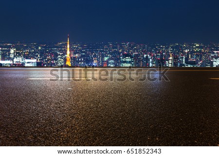 night scene of modern buildings near tokyo tower from empty road