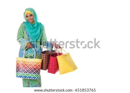 Beautiful asian muslimah woman with bright wicker tote bags. Isolated on the white studio background.Copyspace