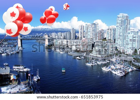 Canadian maple leaf balloons floating over the city of Vancouver for Canada day. 