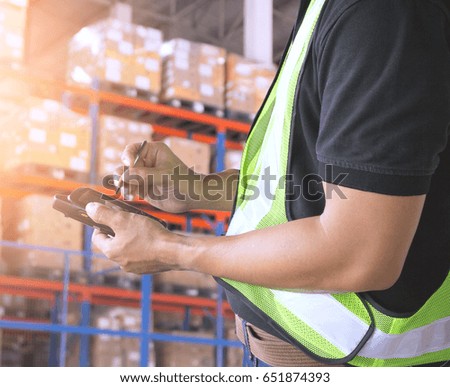 Warehouse worker holding with Barcode scanner and checking in warehouse