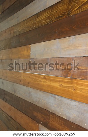 Multiple colors of wood on a wall