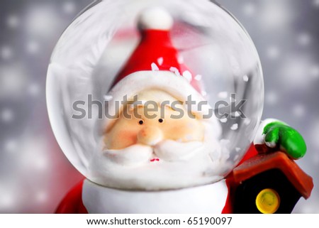 Santa Claus in the snow globe, closeup on Christmas ornament, decorative toy