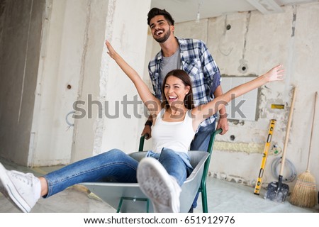 Loving couple is having fun while they are renovating home Royalty-Free Stock Photo #651912976
