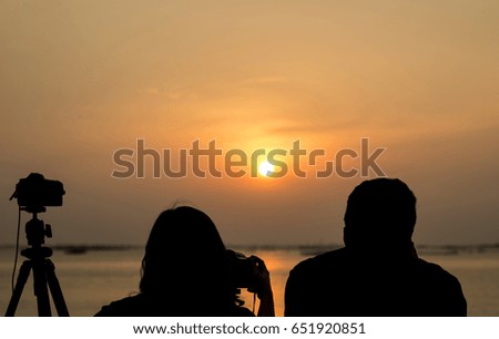 Tourists are shooting sunset at sea