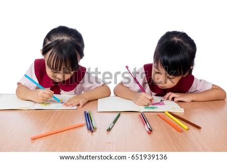 Asian Little Chinese girls drawing with color pencils in isolated white background